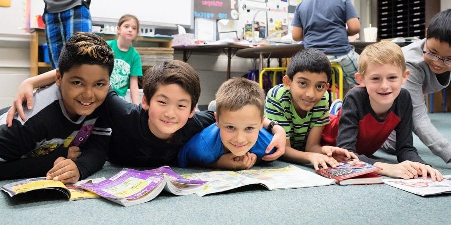 Photo of boys reading on floor